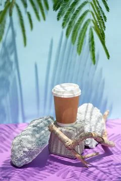 Creative composition from brown craft paper takeaway coffee cup on natural st 스톡 사진