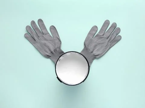 Creative composition with can of white paint and work gloves on blue backgrou Stock Photos