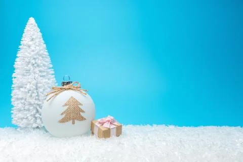 Creative composition with Christmas tree and gift box on blue background. Stock Photos