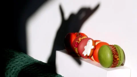 Creative composition of colorful macarons with a hand shadow gesture on a w.. Stock Footage 342501005