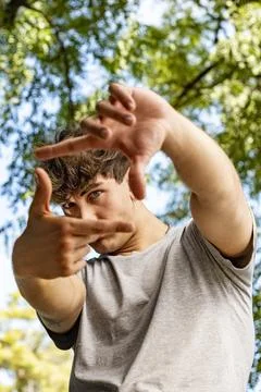 Creative composition concept showing a handsome male student framing his fa.. Stock Photos