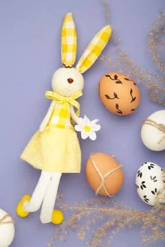 Creative composition with cute Easter bunny rabbit and egg on purple backgr.. Stock Photos