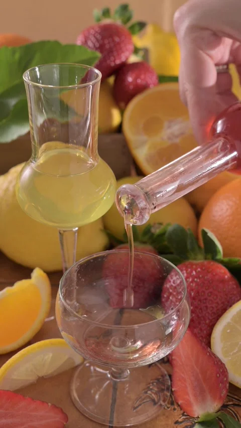 Creative composition featuring strawberry-infused limoncello served in elegant Stock Footage 311766657