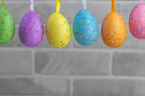 Creative composition with garland of multi-colored decorated eggs. Easter con Stock Photos