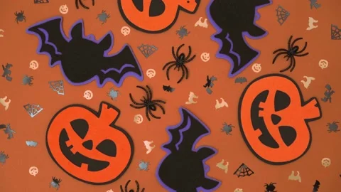 Creative composition of Halloween decorations rotate on an orange background. 4k Video stock 205355234