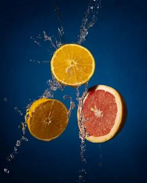 Creative composition image of levitating orange and grapefruit slices with wa Stock Photos