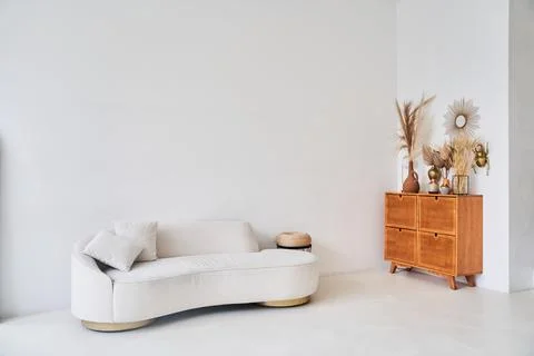A creative composition of the living room interior with an uneven sofa in a Stock Photos