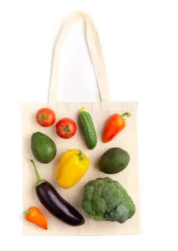 Creative composition of organic vegetables laying on reusable cotton shopping Stock Photos
