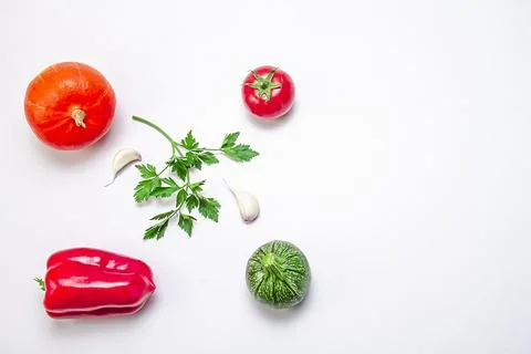 Creative composition of pumpkin, eggplant, bell pepper, sherry tomatoes, garl Stock Photos
