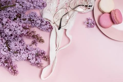 Creative composition with purple lilac flowers and macarons Stock Photos