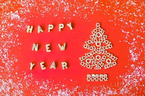 Creative composition of raw wheat pasta - christmas tree and text Happy new y Stock Photos