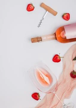 Creative composition with rose wine and strawberries Stock Photos