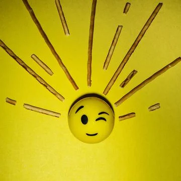 A creative composition of a smiley face and rays of light from it, a minimali Stock Photos