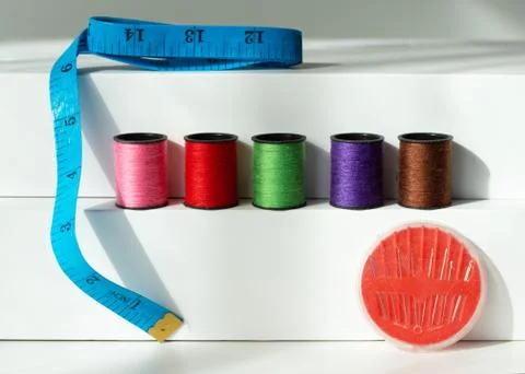 Creative composition with spools of colored threads and scissors. Sewing acce Stock Photos