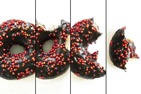 Creative concept of biting eating delicious sweet sugar black doughnut donu.. Stock Photos