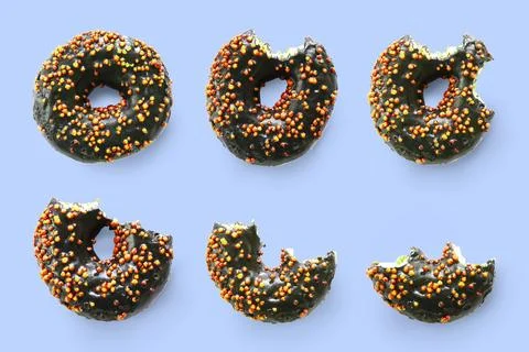 Creative concept of biting eating delicious sweet sugar black doughnut donu.. Stock Photos