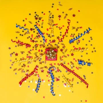 Creative concept with festive decor on yellow background. Stock Photos