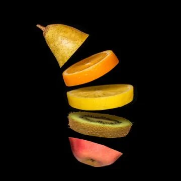 Creative concept with flying fruit. Pear, orange, lemon, kiwi, apple Stock Photos