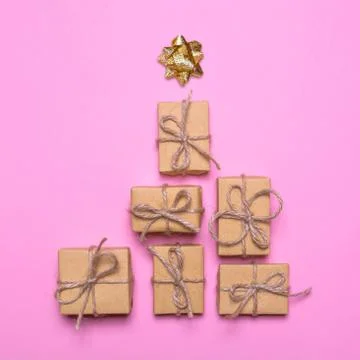 Creative concept with gift boxes. Christmas tree of gifts on a pink backgroun Stock Photos