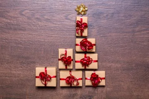 Creative concept with gift boxes. Christmas tree of gifts on a wooden backgro Stock Photos