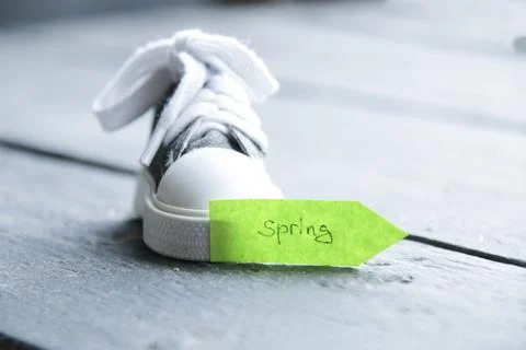 Creative concept, green pointer with the inscription spring Stock Photos