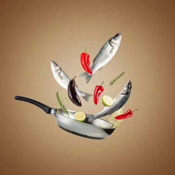 Creative concept with a grill pan, fresh seabass fishes and vegetables. 写真素材