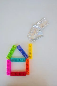 Creative concept of a house made from weekly pill organizers with blister p.. Stock Photos