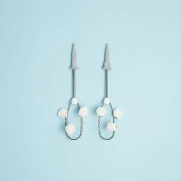 Creative concept made of electric egg beater and white rose flowers on pastel Stock Photos