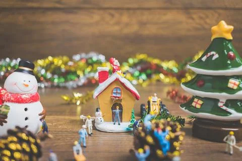 Creative concept with miniature people creating Christmas decorations on a .. Stock Photos