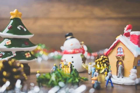 Creative concept with miniature people creating Christmas decorations on a .. Stock Photos