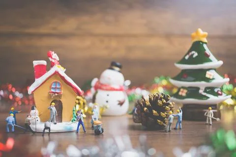 Creative concept with miniature people creating Christmas decorations on a .. Stock Photos