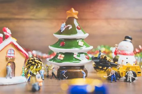 Creative concept with miniature people creating Christmas decorations on a .. Stock Photos