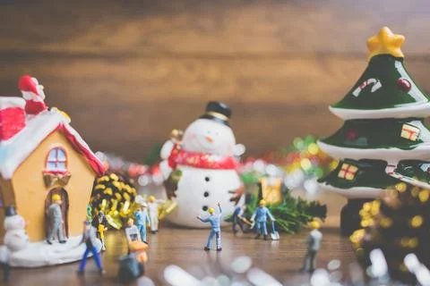 Creative concept with miniature people creating Christmas decorations on a .. Stock Photos