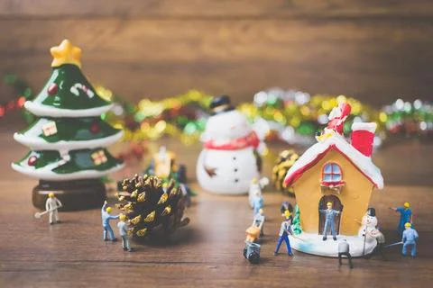 Creative concept with miniature people creating Christmas decorations on a .. Stock Photos