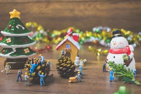 Creative concept with miniature people creating Christmas decorations on a .. Stock Photos