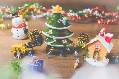 Creative concept with miniature people creating Christmas decorations on a .. Stock Photos