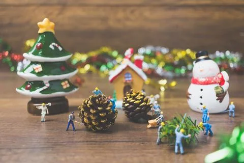 Creative concept with miniature people creating Christmas decorations on a .. Stock Photos