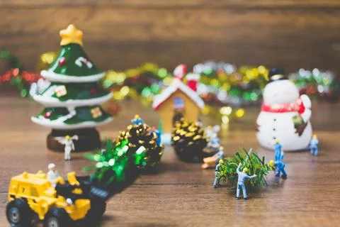 Creative concept with miniature people creating Christmas decorations on a .. Stock Photos