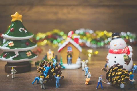 Creative concept with miniature people creating Christmas decorations on a .. Stock Photos