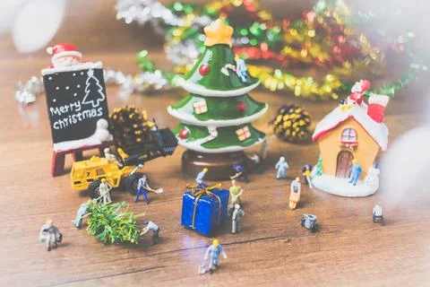Creative concept with miniature people creating Christmas decorations on a .. Stock Photos