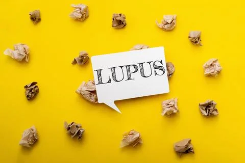 Creative concept with speech bubble displaying the word lupus on vibrant yellow Stock Photos
