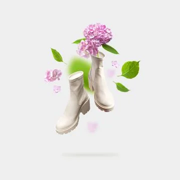 Creative concept of spring shoes. Flying fashionable beige leather women's boots Stock Photos