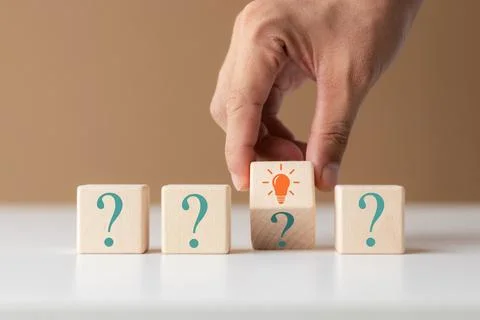 Creative concept. Think different, wooden cube with question mark and light.. Stock Photos