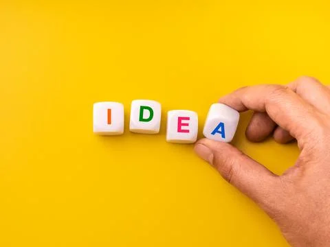 Creative concept of word IDEA formed with colorful blocks arranged by hand .. Stock Photos