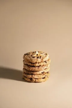 Creative conceptual idea, stack of cookies as a burning candle, vertical banner Stock Photos