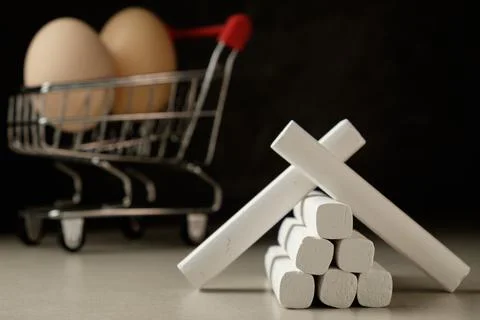 Creative construction of white chalk in front of eggs in a grocery cart Stock Photos