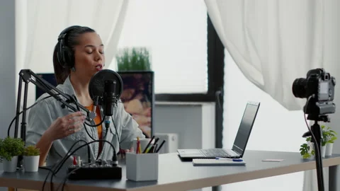 Creative content creator recording vlog in home studio while tweaking knobs on Stock Footage 211782490