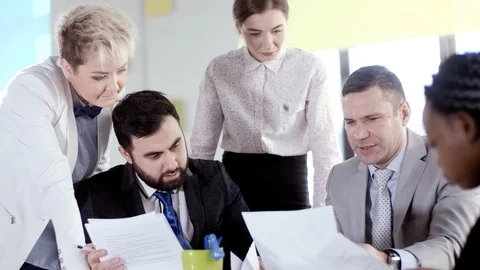 Creative conversation of a multinational group of businessmen. Discussion of a Stock Footage 123576301