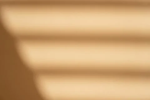 Creative copy space with shadows on a shiny soft beige wall. Top view window 스톡 사진
