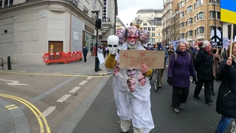 Creative costume stop oligarchs putin London march support ukraine Video stock 171484864